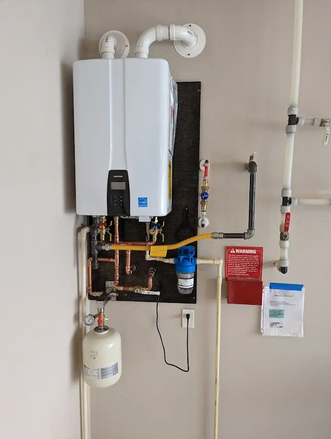 Professional plumber installing copper piping in a Coral Gables home